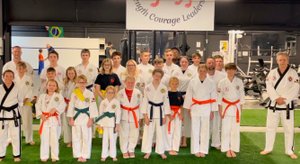 Large group photo of newly promoted students.